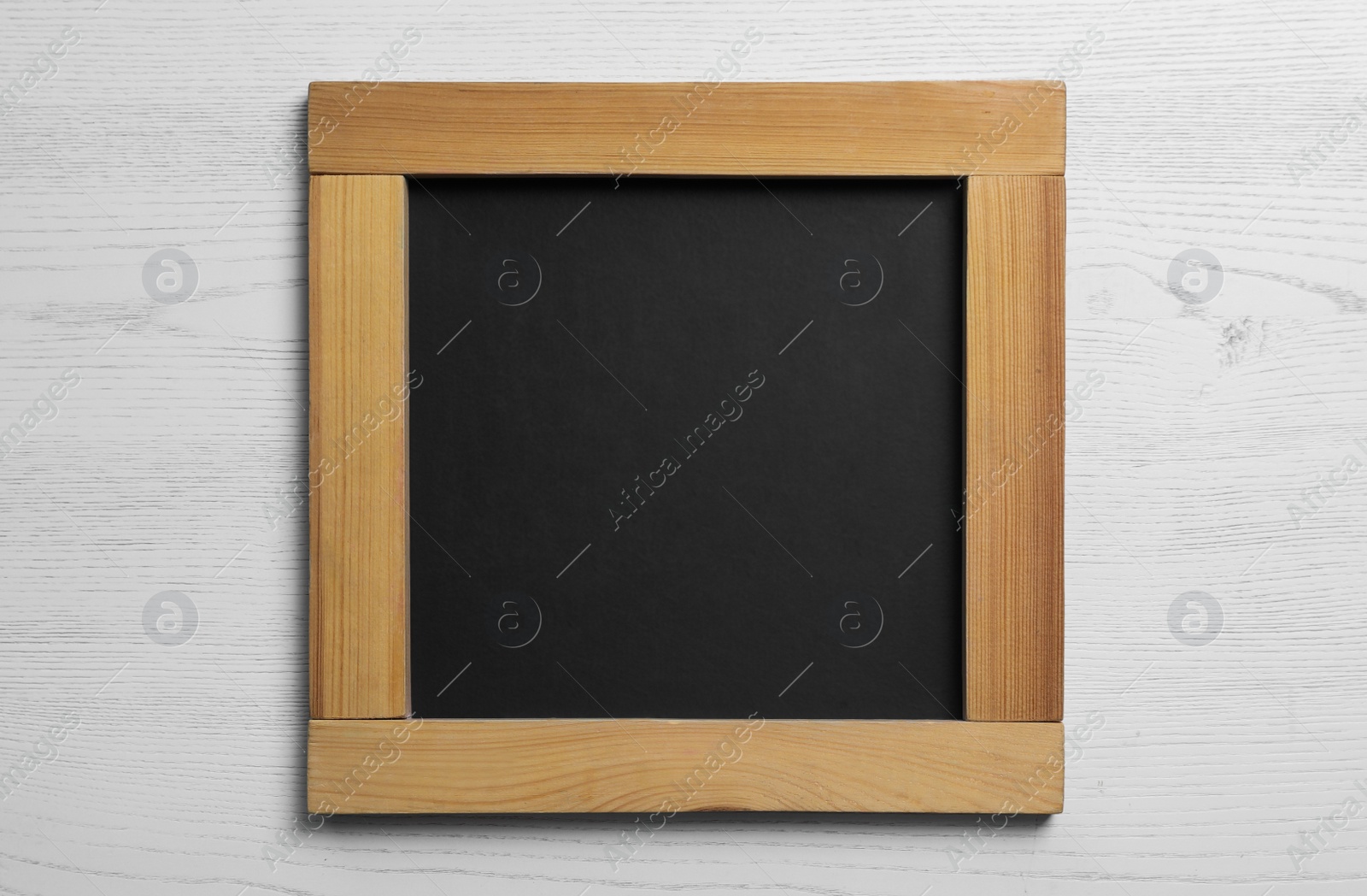 Photo of Blank chalkboard on white wooden background, top view. Space for text