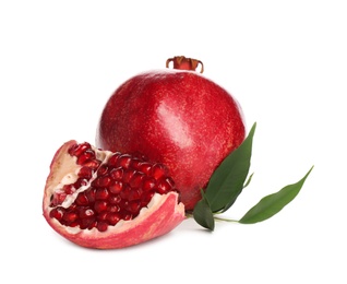 Ripe pomegranates with leaves on white background