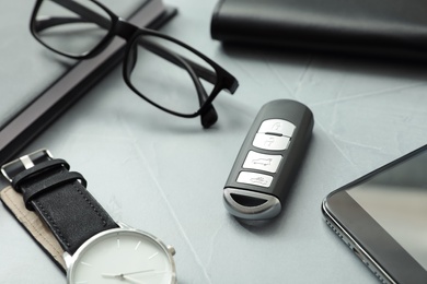 Photo of Composition with male accessories and remote car key on grey background