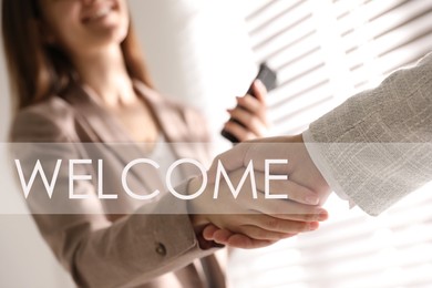 Welcome to team. Employee shaking hands with intern in office, closeup