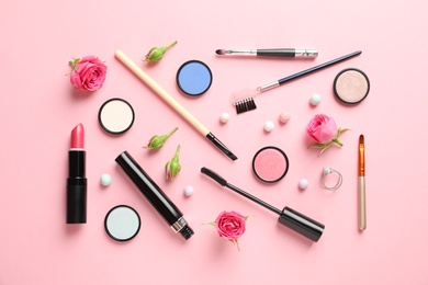 Photo of Flat lay composition with products for decorative makeup on pastel pink background