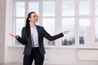 Happy real estate agent showing new apartment