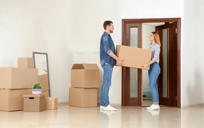 Photo of Couple with moving box in their new house