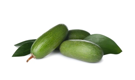 Photo of Fresh whole seedless avocados with leaves isolated on white