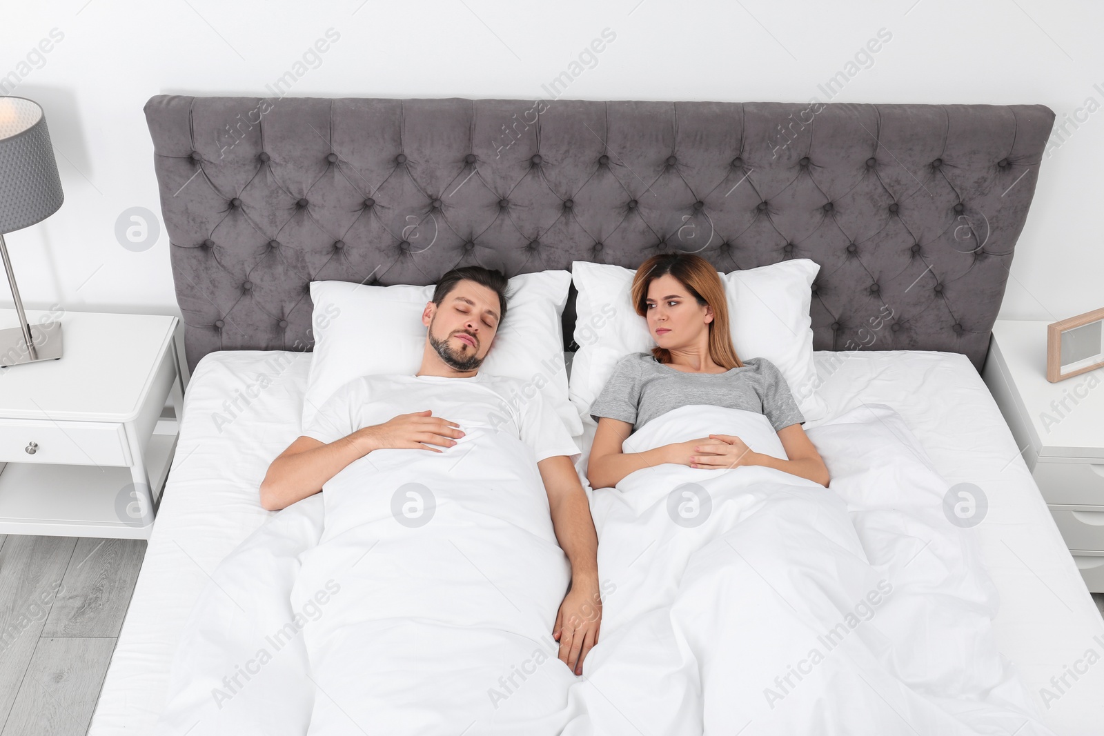 Photo of Couple with relationship problems in bed at home