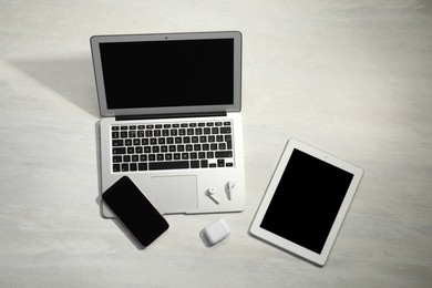 Set of different gadgets on wooden table, above view