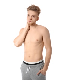 Portrait of young man with slim body on white background