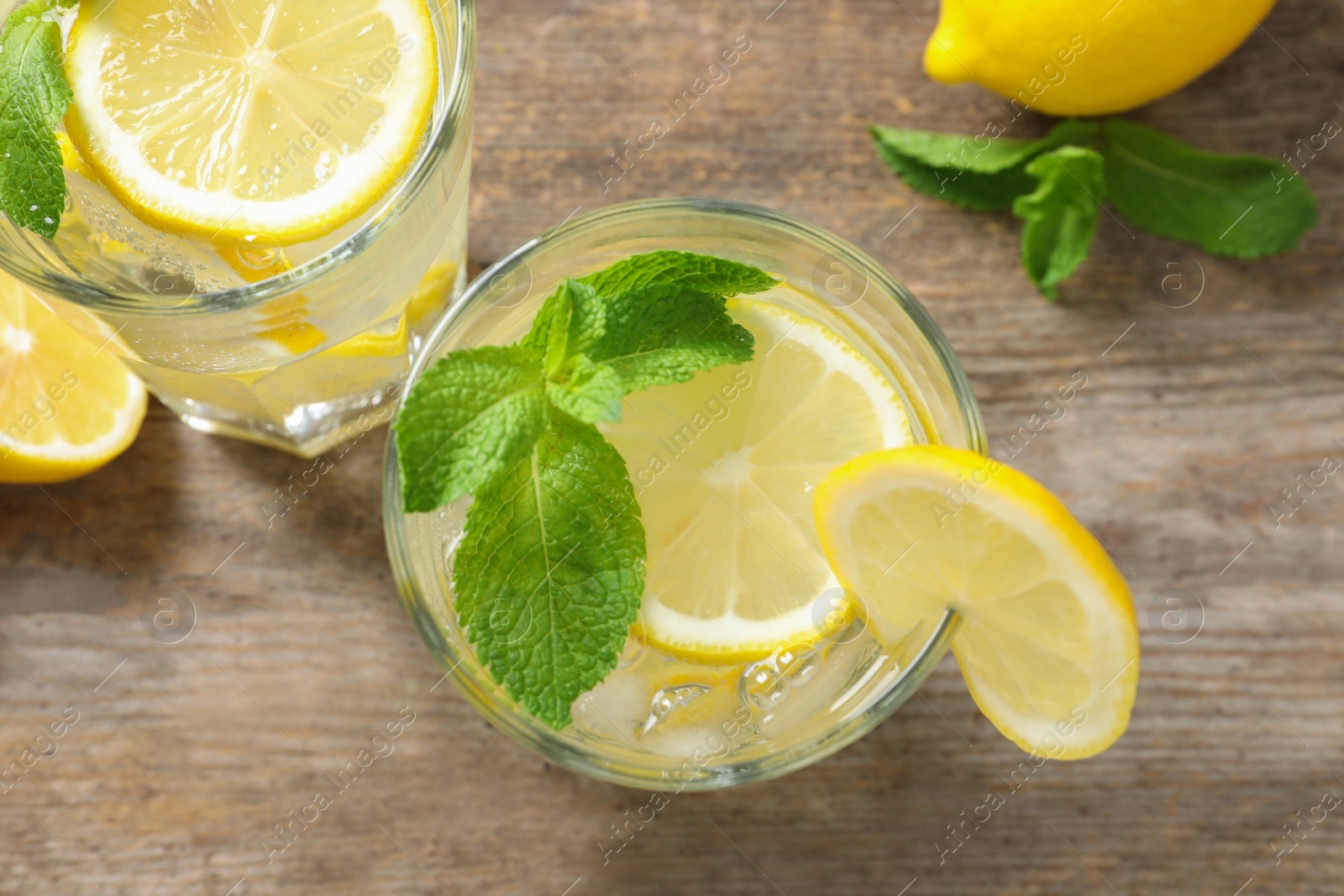 Photo of Flat lay composition with glass of natural lemonade on table