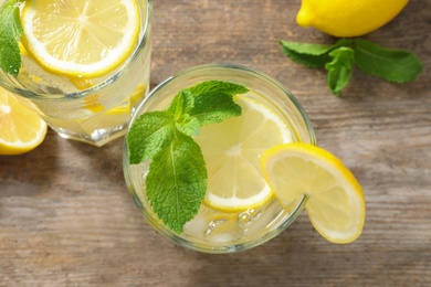 Photo of Flat lay composition with glass of natural lemonade on table