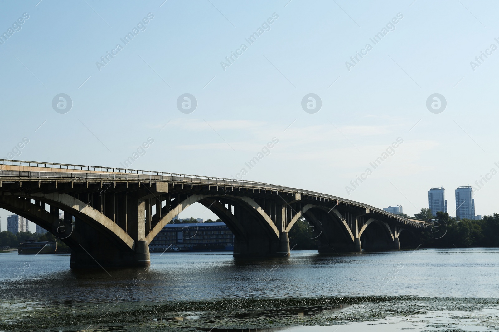 Photo of Beautiful view of arch bridge over river on sunny day