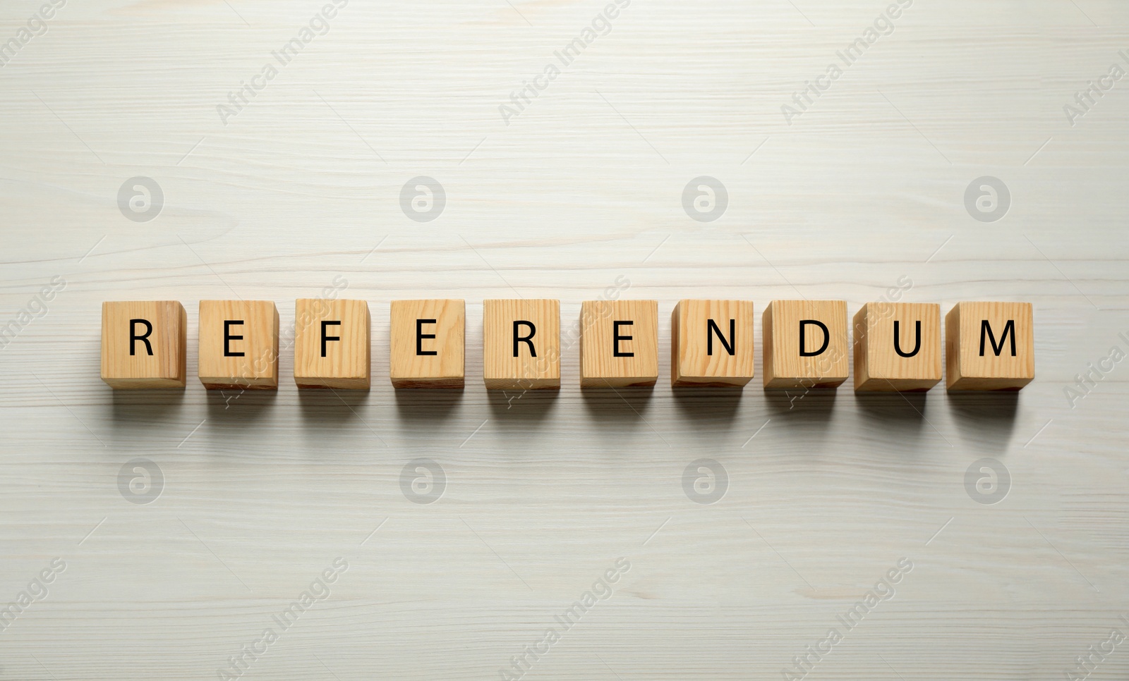 Photo of Word Referendum of cubes on white wooden table, flat lay