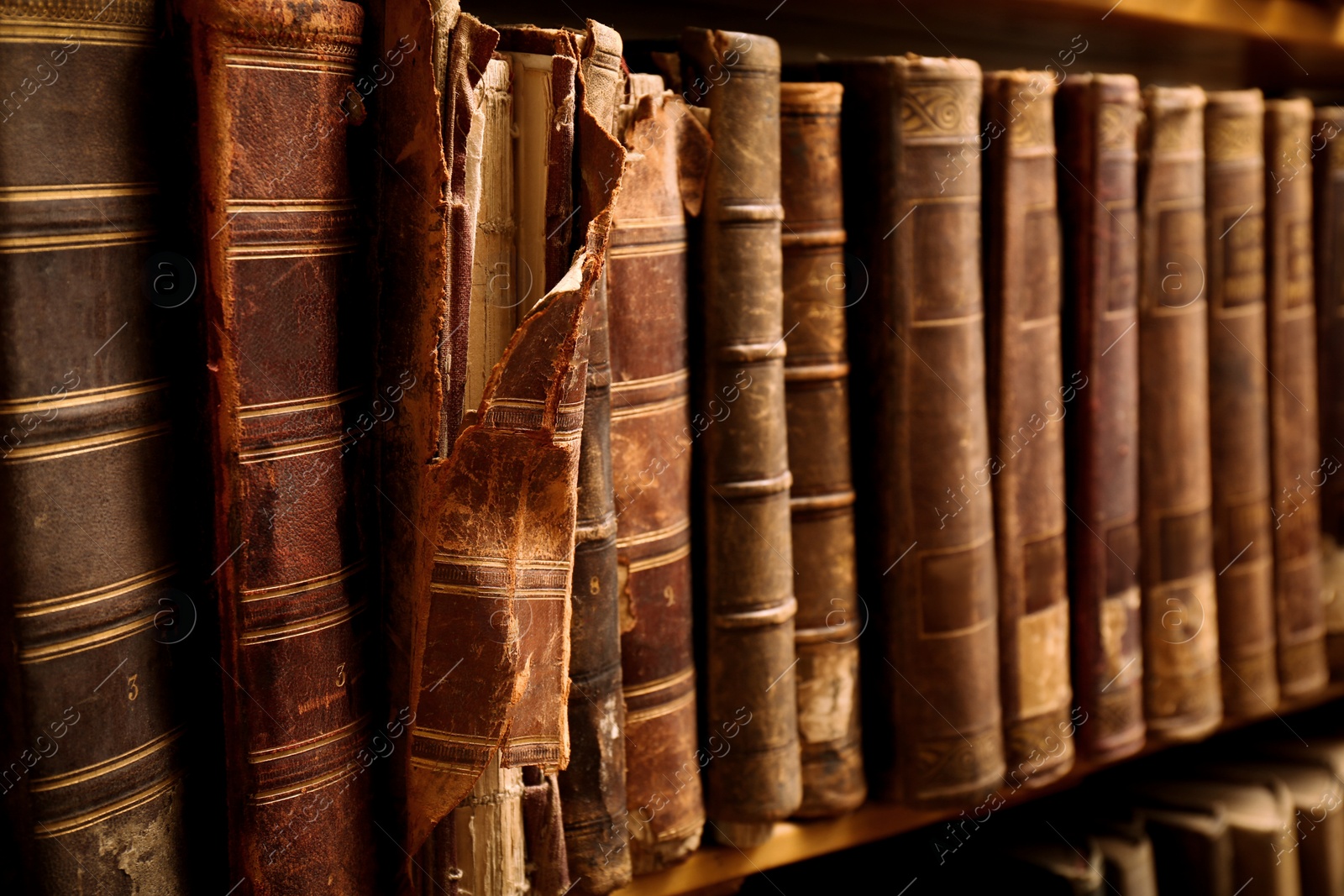 Image of Collection of old books on shelf in library, closeup