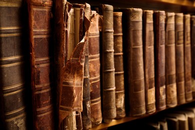 Image of Collection of old books on shelf in library, closeup