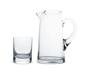 Empty glass and jug isolated on white