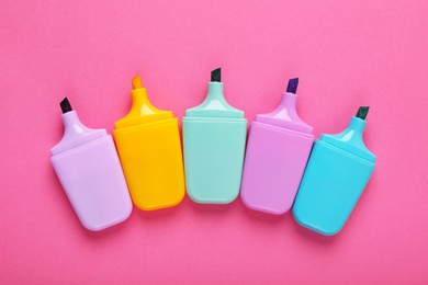 Photo of Many colorful markers on pink background, flat lay