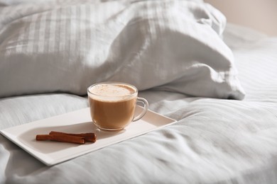 Photo of Tray with morning coffee on soft blanket. Space for text