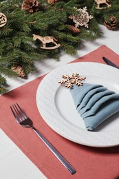 Luxury festive place setting with beautiful decor for Christmas dinner on white wooden table