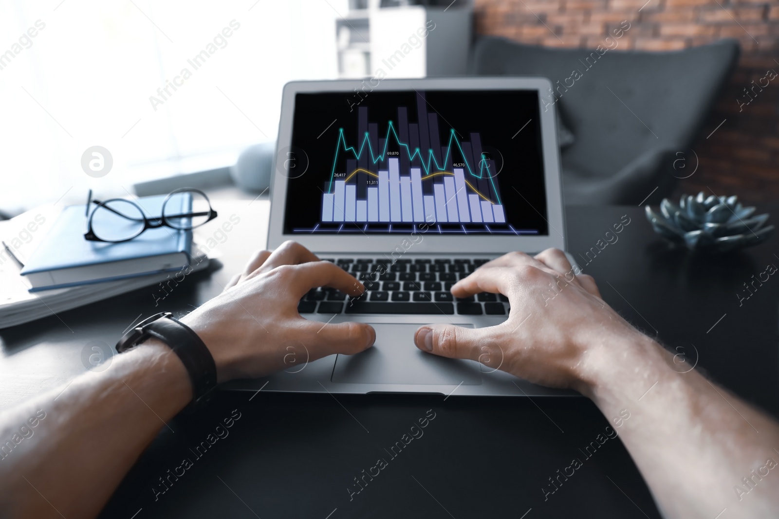 Image of  Broker working with laptop at table, closeup. Forex trading