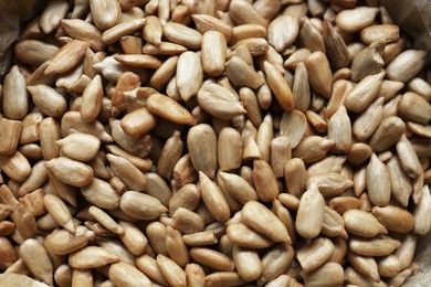 Photo of Pile of peeled sunflower seeds as background, closeup