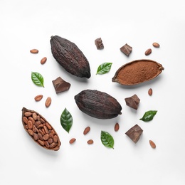 Photo of Cocoa pods with beans, powder and chocolate pieces on white background, top view