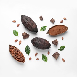 Cocoa pods with beans, powder and chocolate pieces on white background, top view