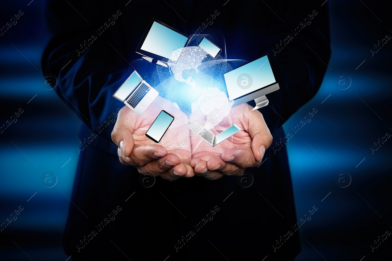 Image of Young businessman holding different devices in hands on color background, closeup 