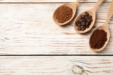 Photo of Spoons with instant, ground coffee and roasted beans on white wooden table, flat lay. Space for text