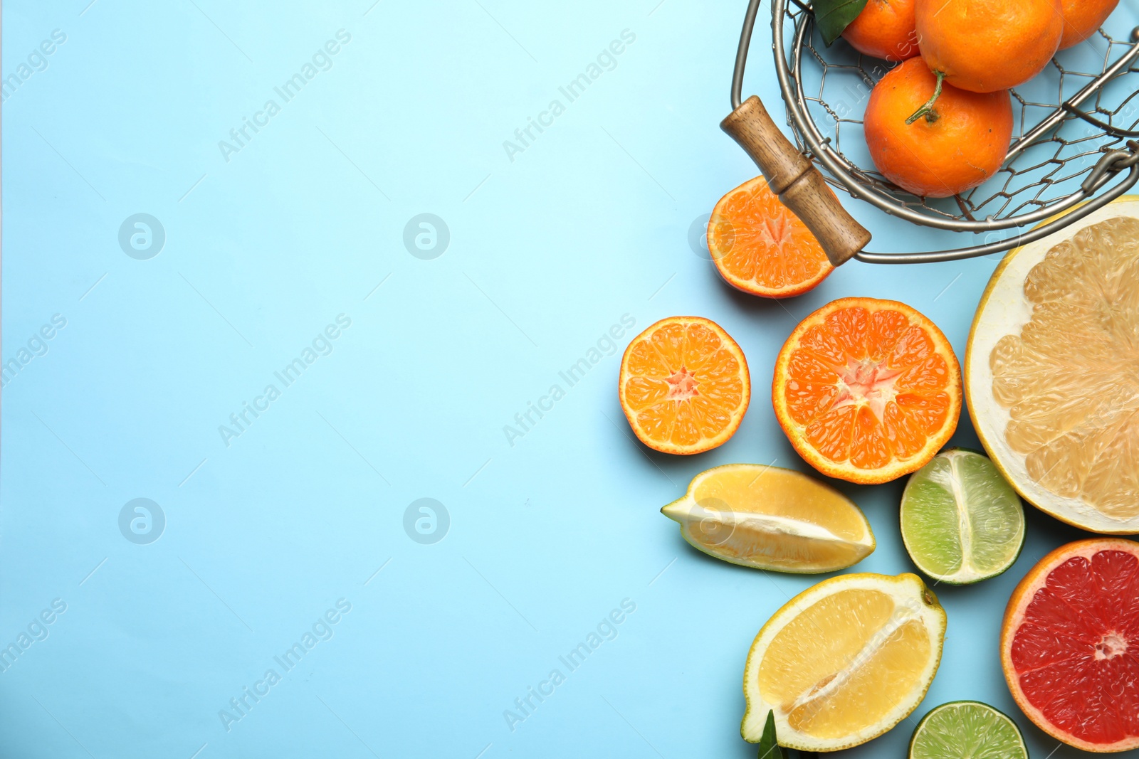 Photo of Different citrus fruits on color background, top view. Space for text