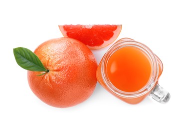 Photo of Tasty freshly made grapefruit juice and fruits on white background, top view