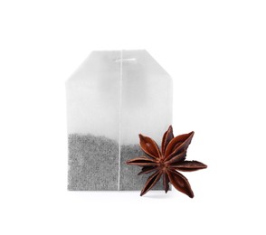 New tea bag and anise star on white background