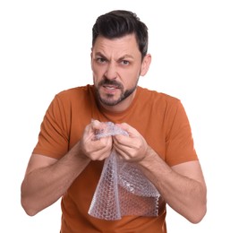 Man popping bubble wrap on white background. Stress relief