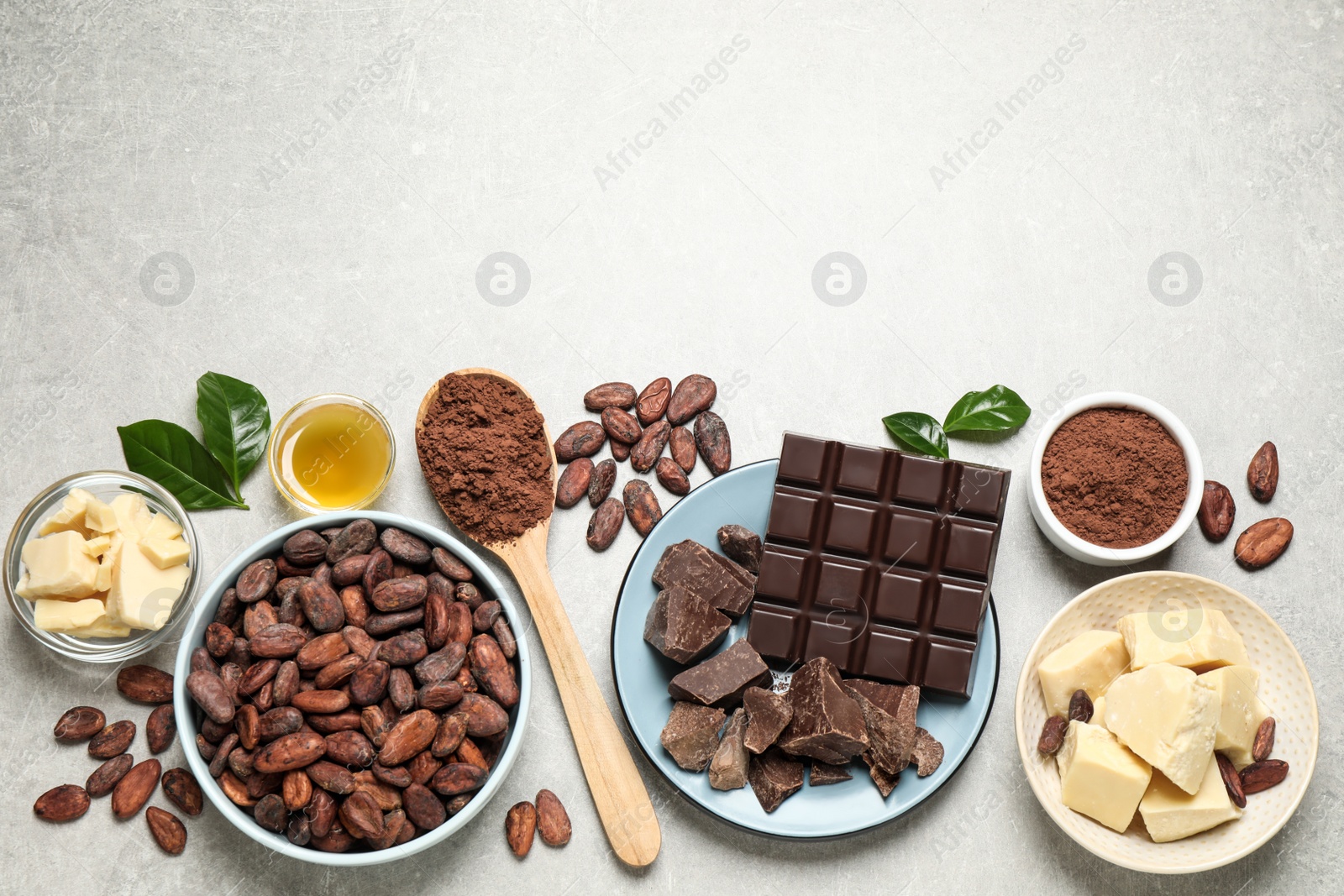 Photo of Flat lay composition with organic cocoa butter on light grey table. Space for text