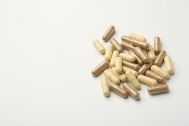 Different vitamin capsules on white background. Space for text