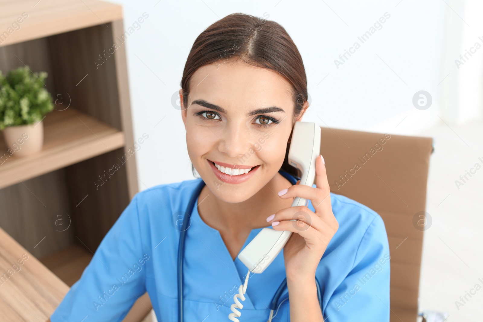 Photo of Female medical assistant at workplace in clinic. Health care service