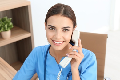 Photo of Female medical assistant at workplace in clinic. Health care service