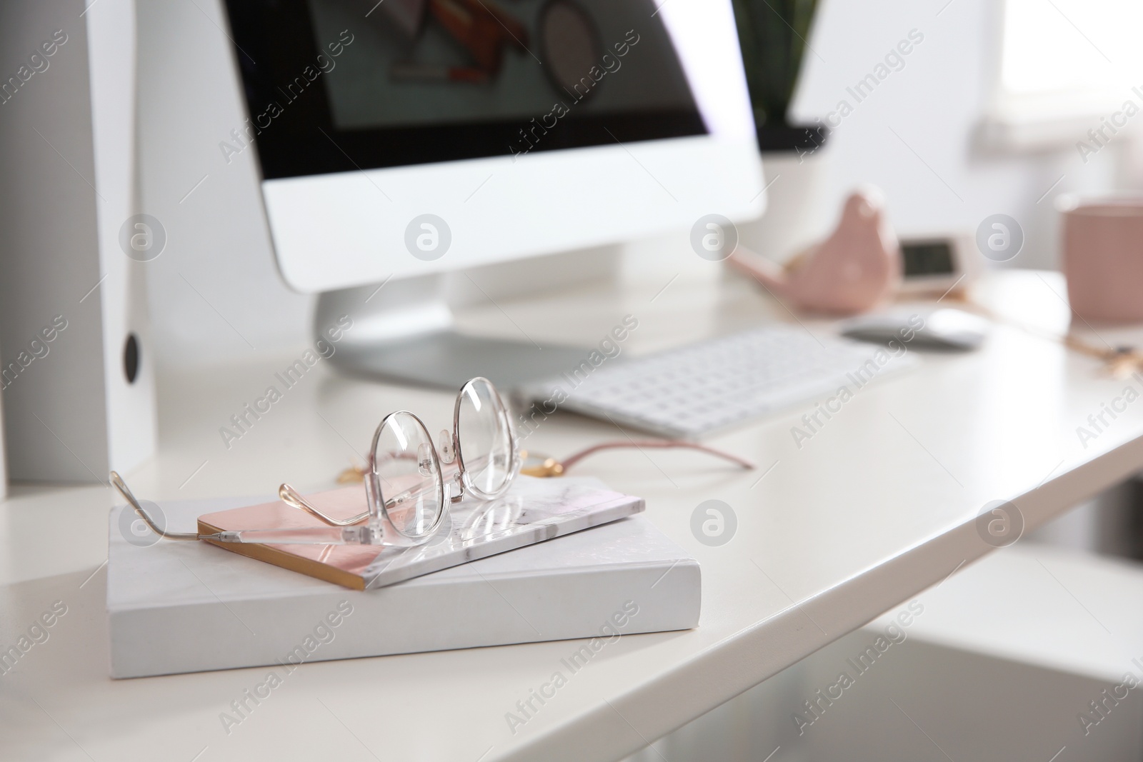 Photo of Comfortable workplace with computer on desk in home office, closeup