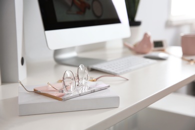 Comfortable workplace with computer on desk in home office, closeup