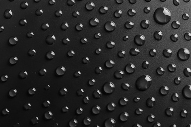 Photo of Water drops on black background, top view