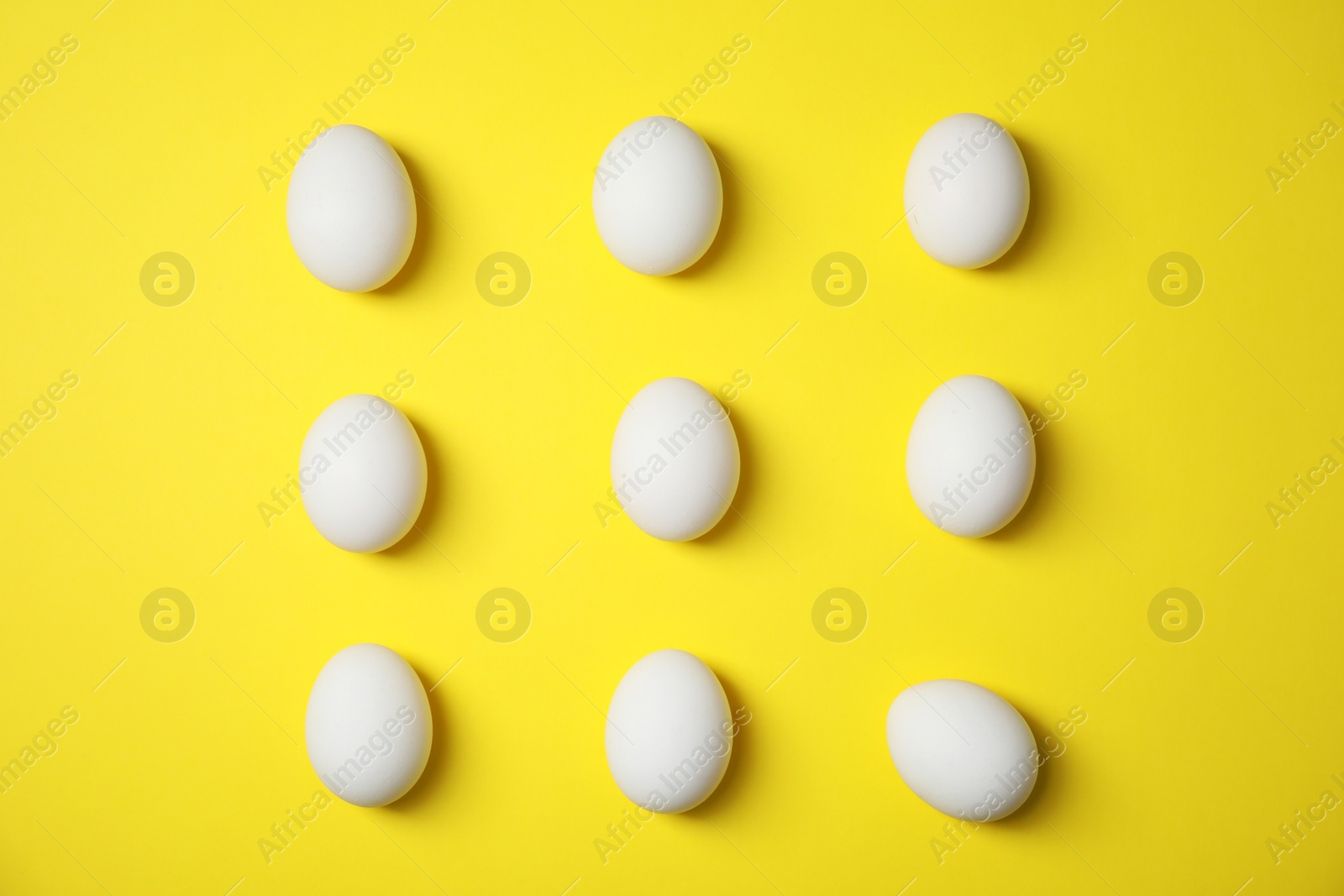 Photo of Raw chicken eggs on color background, top view