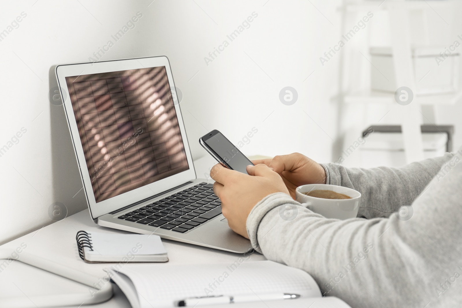 Photo of Young man using calendar app on laptop in office, closeup