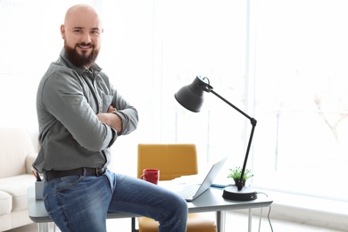 Portrait of confident young man in room