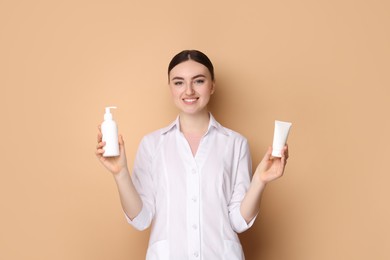 Photo of Cosmetologist with cosmetic products on beige background