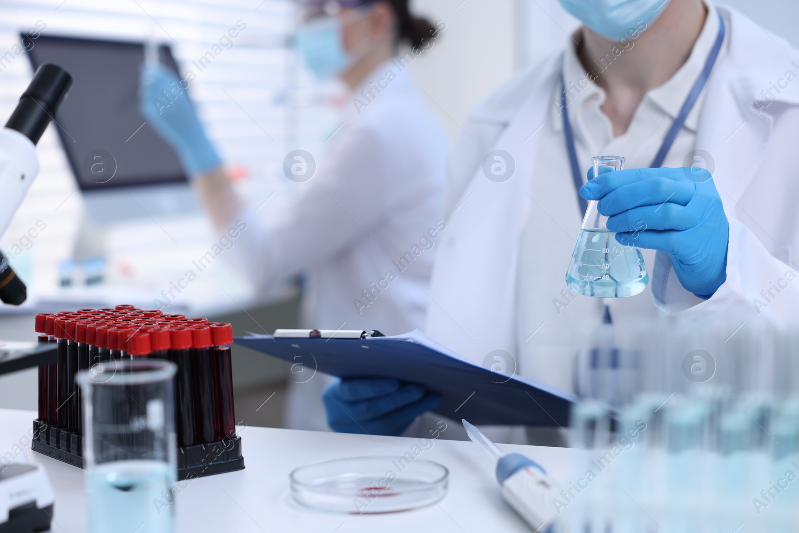 Photo of Scientists working with samples in laboratory, closeup. Medical research