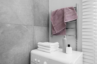 Clean terry towel on heated rail in bathroom