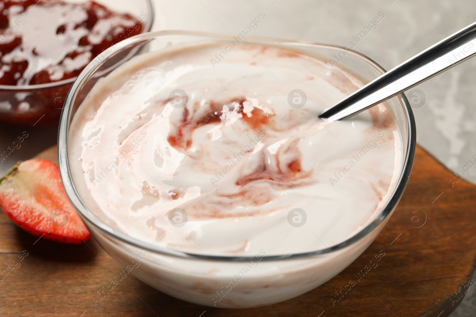 Photo of Tasty yoghurt with jam and strawberry on table, closeup