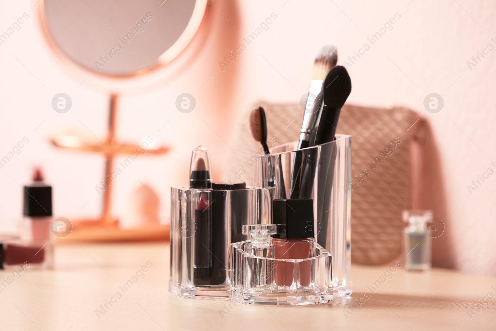 Photo of Set of decorative cosmetic products for makeup on dressing table. Space for text