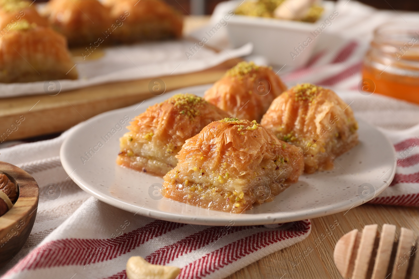 Photo of Delicious sweet baklava with pistachios on table, closeup