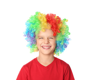Photo of Little boy in clown wig on white background. April fool's day