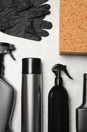 Photo of Flat lay composition with car cleaning products, sponge and gloves on light grey table