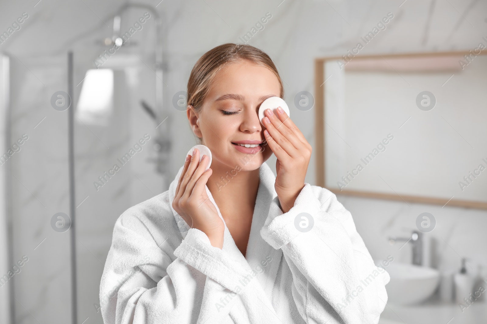 Photo of Beautiful young woman with cotton pads indoors